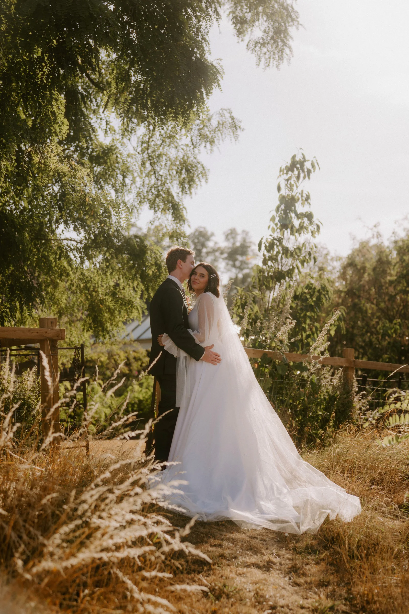 Newlyweds portrait in countryside meadow