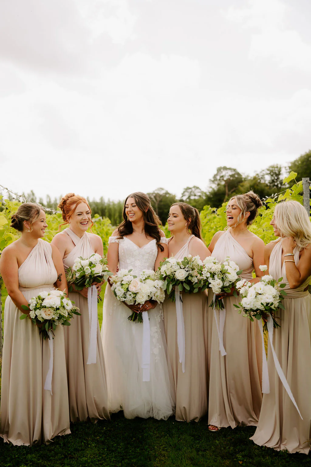 Llanerch Vineyard Drinks Reception | Hensol Bethan and James smiling together during their drinks reception at Llanerch Vineyard