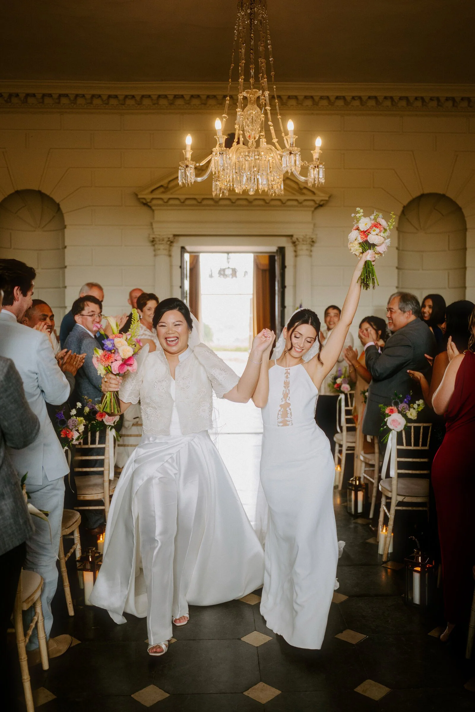 Two brides celebrating after their wedding ceremony