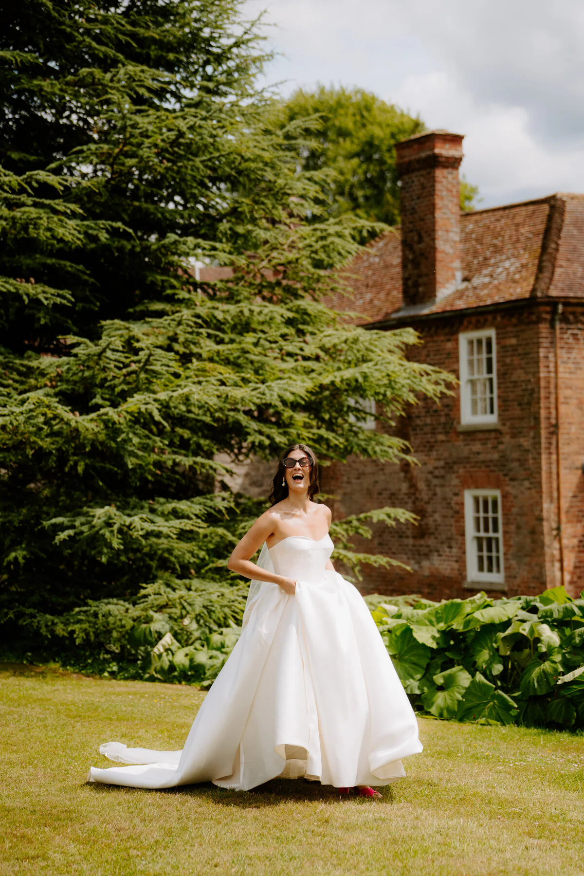 Dsc09761 Bride smiling in the garden outside a country house wedding venue.
