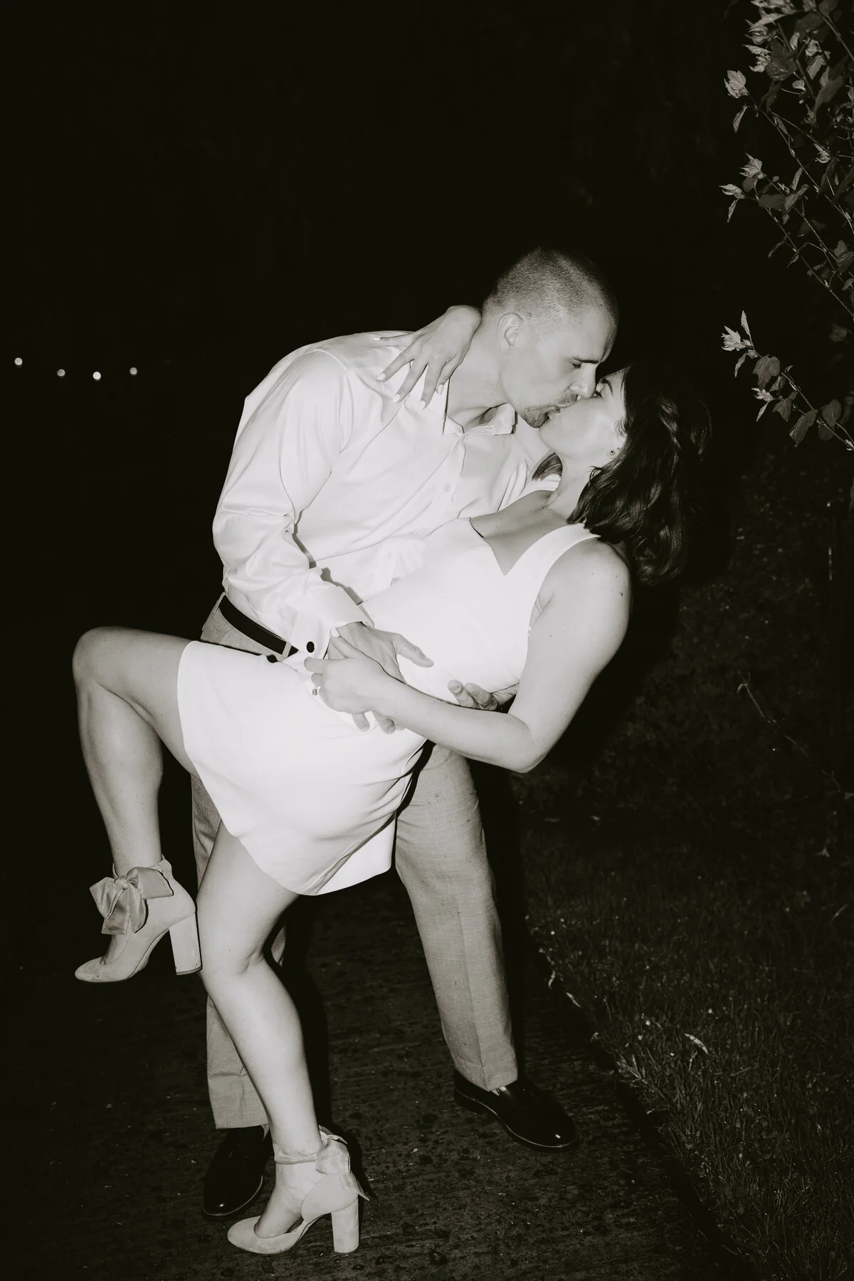 Dsc06559 Black and white flash photograph of a couple kissing during an evening dip in a short white dress.