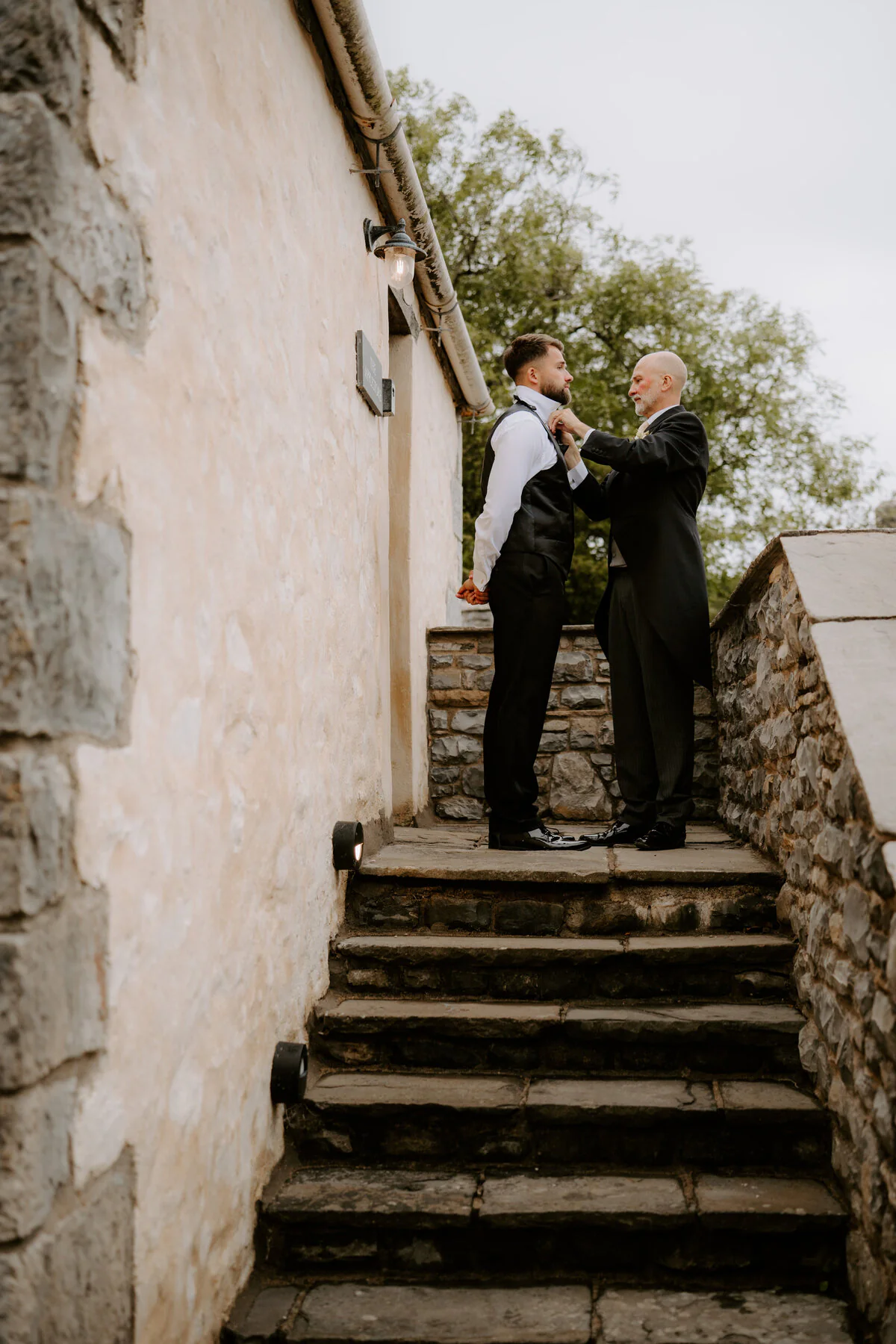 Dsc08000 Groom having his tie adjusted on stone steps before the wedding ceremony.