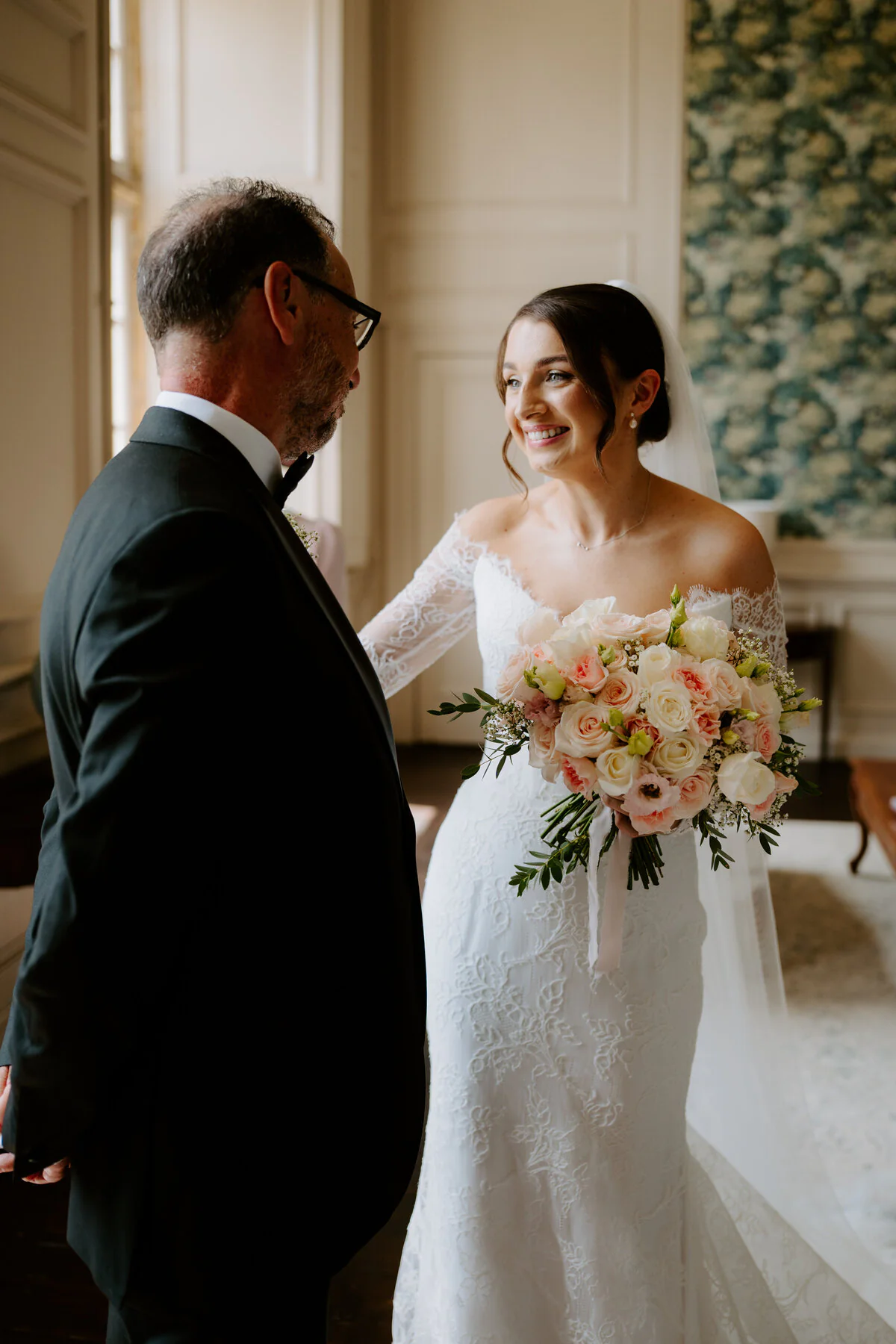 Dsc02262 Smiling bride holding her bouquet during an emotional moment with her father.