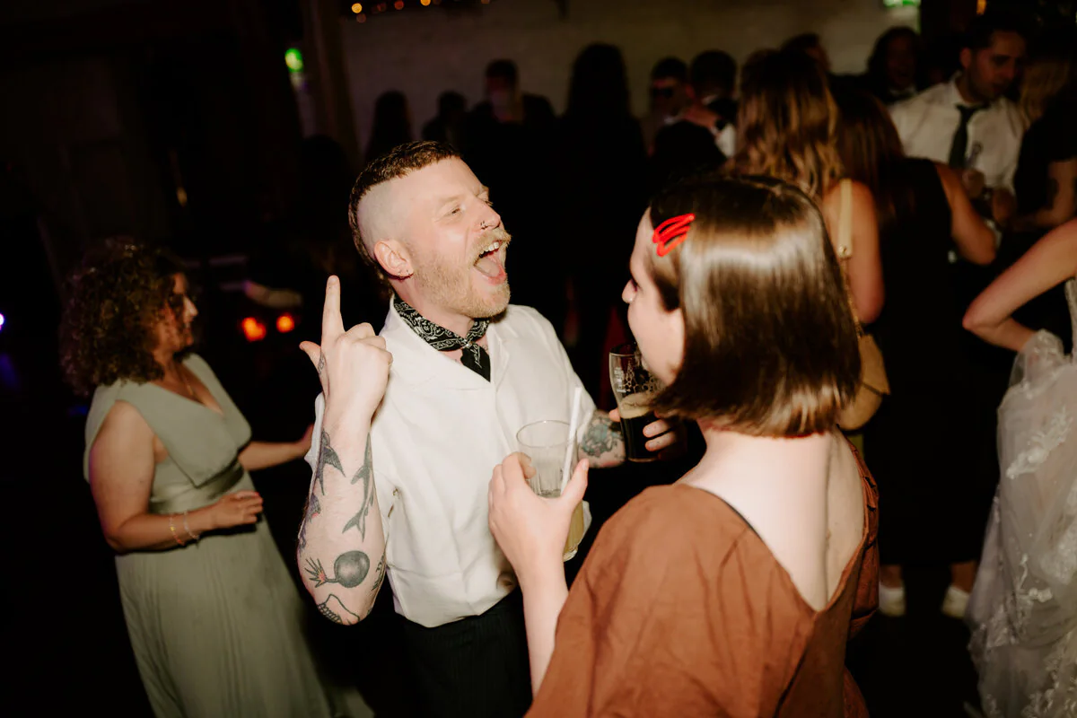 Dsc08796 Wedding guests laughing together on the dance floor during the evening reception.