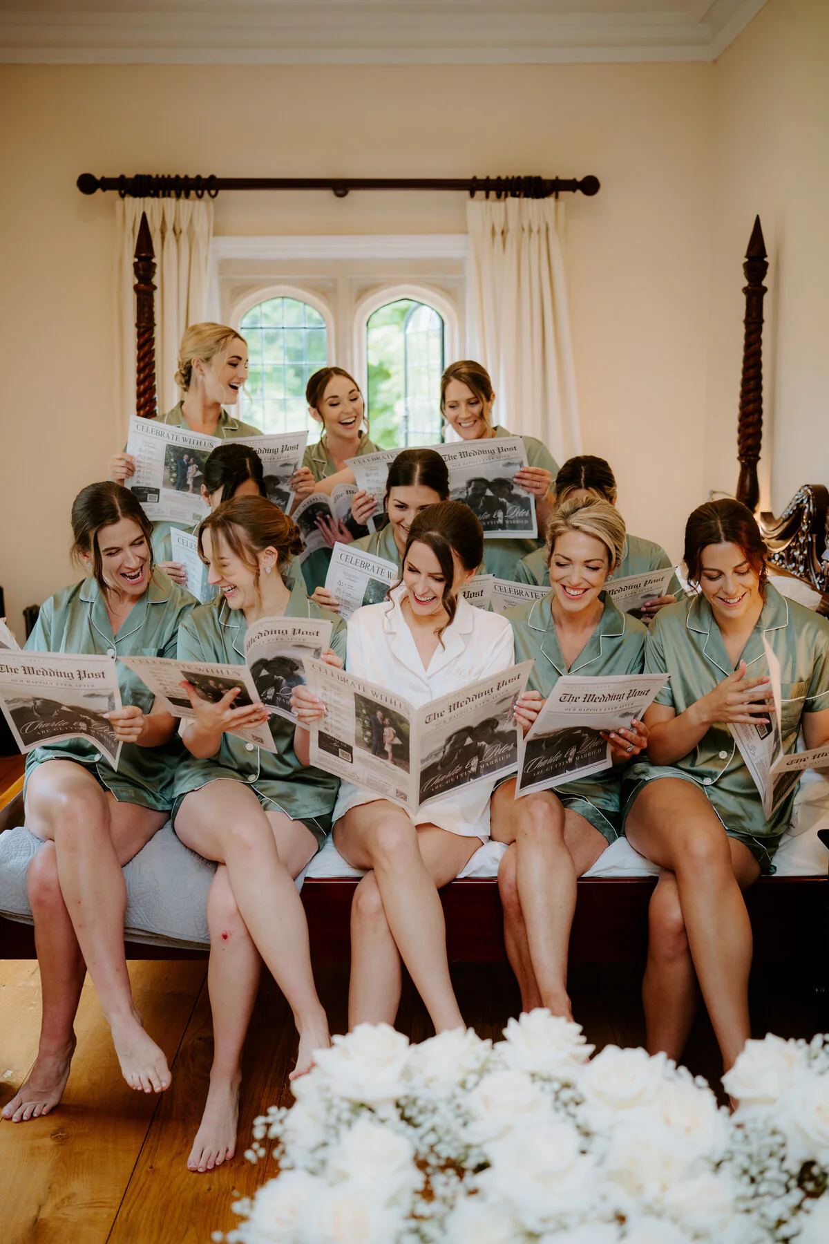 Charlie And Peter 65 Bride and bridesmaids laughing together while getting ready on the wedding morning.