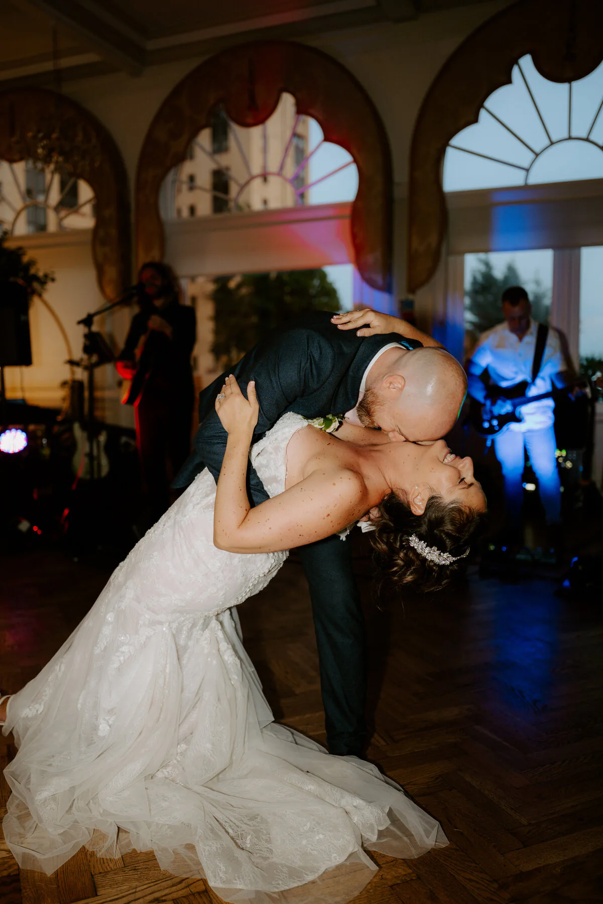 Dsc03311 First-dance dip in front of a live band beneath art-deco arched windows.
