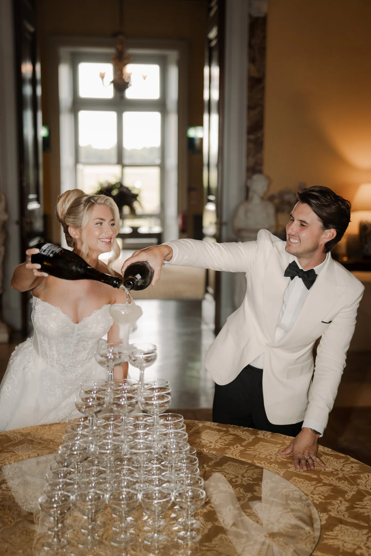 Ca100728 Champagne coupe tower in a stately home hall.