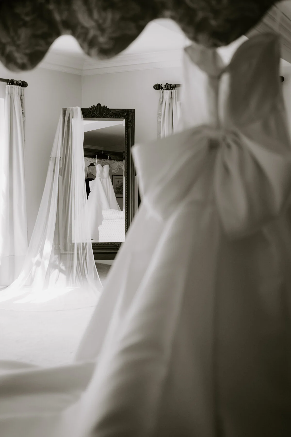 Dsc07570 Black and white photograph of a wedding dress and veil reflected in a bedroom mirror.