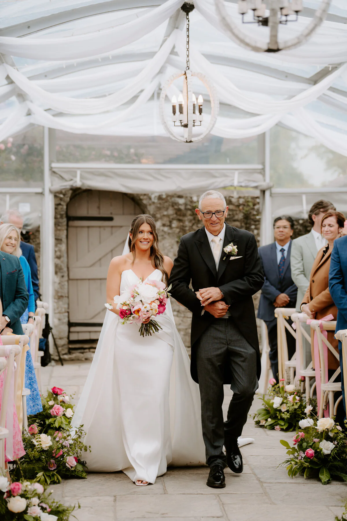 Dsc04567 Father walking the bride down the aisle inside a marquee wedding ceremony.