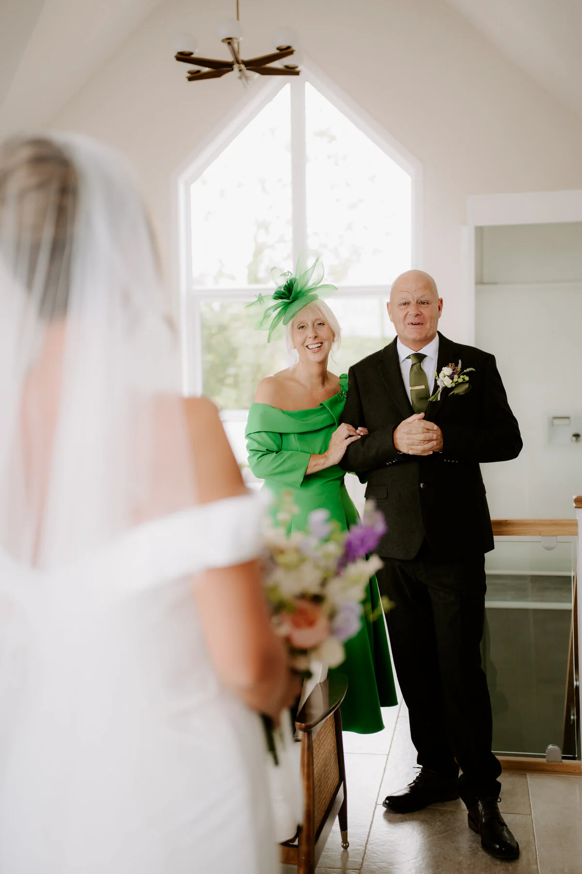 Dsc05701 Parents seeing the bride for the first time, her mother in a green dress and fascinator.