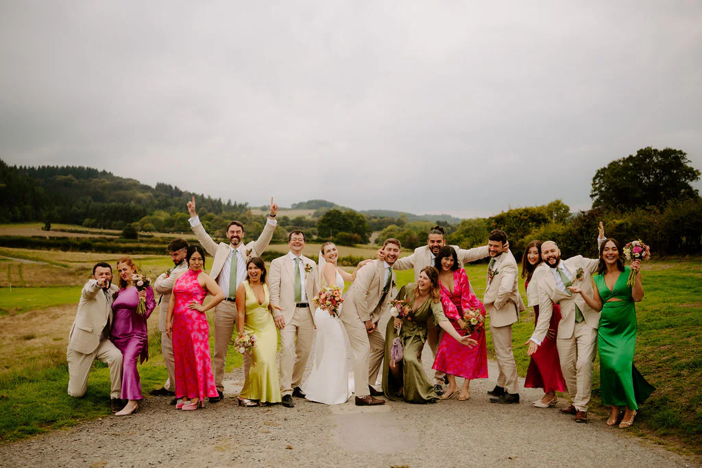 Wilde Lodge Wedding Full Group Photo | Shropshire & Welsh Border Big celebratory wedding group photo of all guests on the lawn at Wilde Lodge in the Shropshire hills