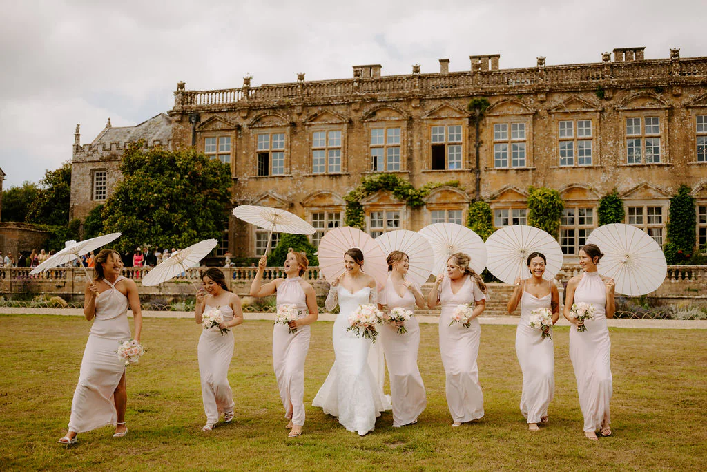 Brympton House Wedding Photography & Film | Yeovil, Somerset Katherine & Marcus walking along the tranquil lake and formal gardens at Brympton House in Yeovil at golden hour sunset