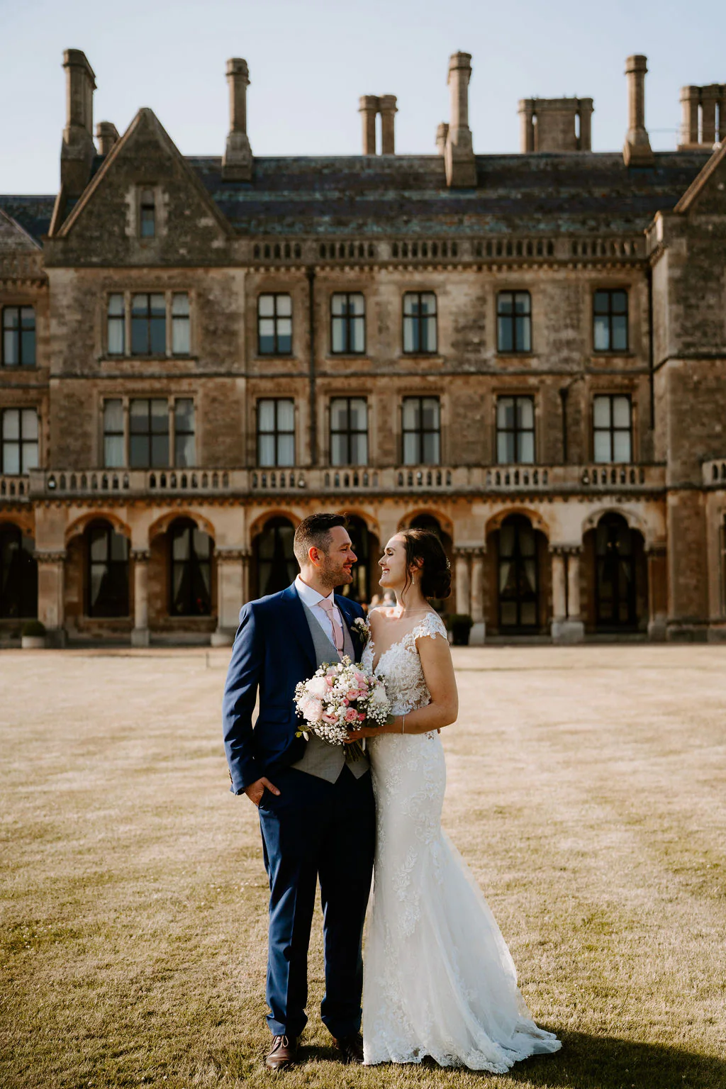 Walton Hall Wedding Photography & Film | Wellesbourne, Warwick Kate & Josh romantic couple portrait in front of the 16th-century chapel at Walton Hall in Wellesbourne