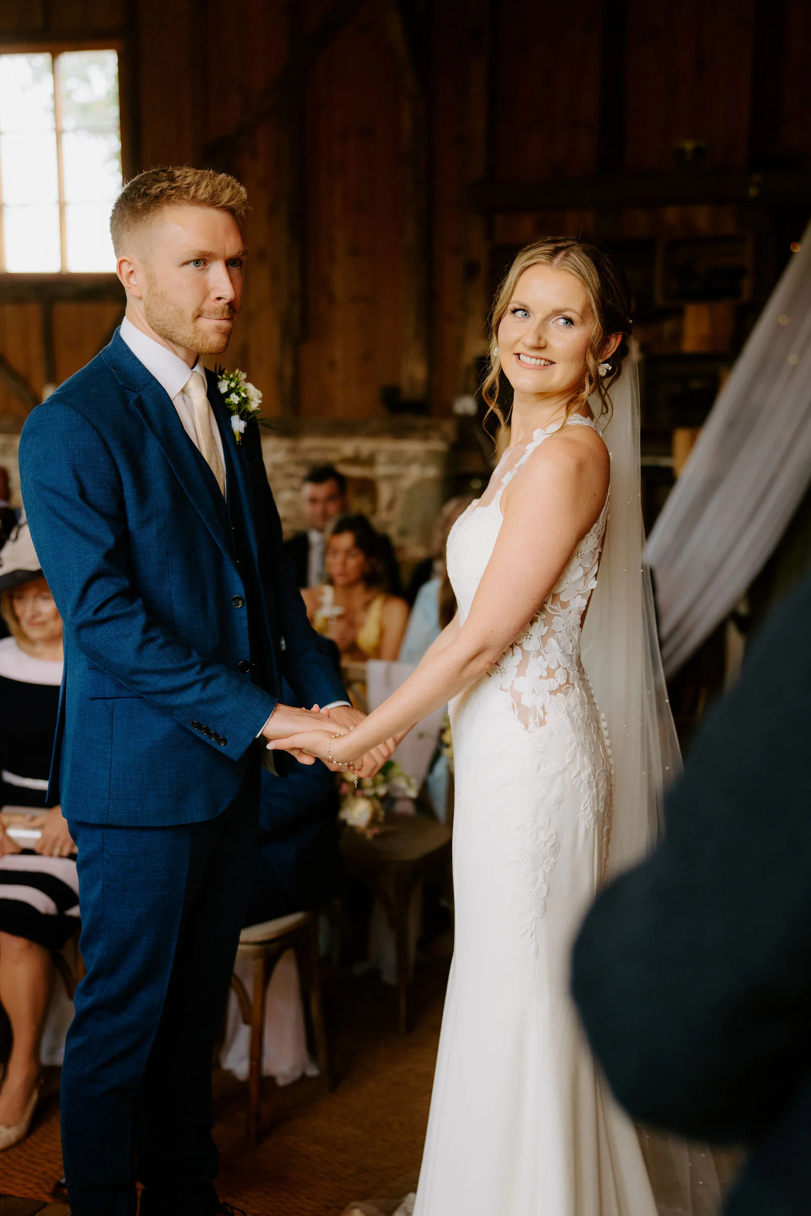 Bowerchalke Barn Confetti Celebration | Salisbury, Wiltshire Vanessa and Harvey laughing joyfully as confetti showers over them outside Bowerchalke Barn