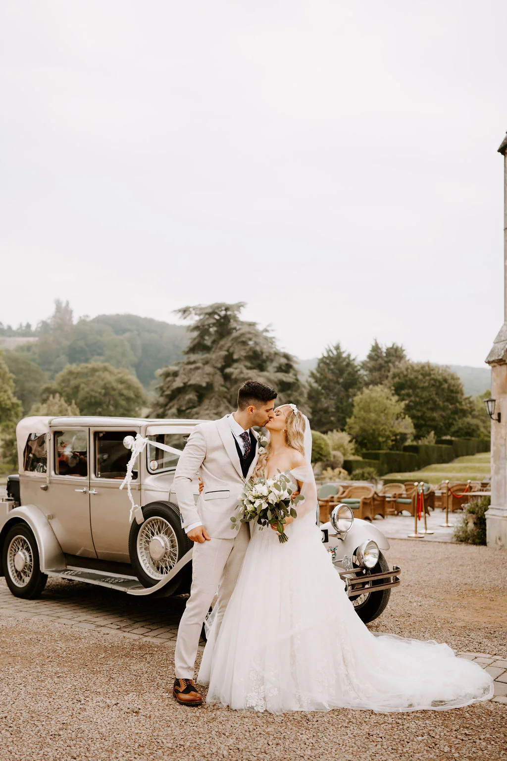 Dumbleton Hall Wedding Photography & Film | Evesham, Worcestershire Lucy & Christian confetti celebration outside the 19th-century stone manor at Dumbleton Hall